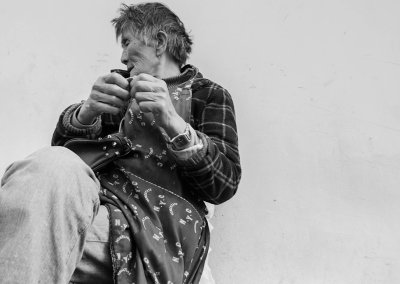 Elderly men and women sitting quietly by the roadside
