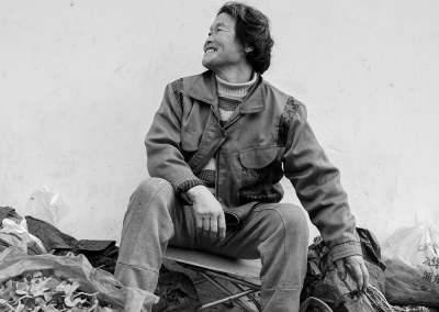 Elderly men and women sitting quietly by the roadside