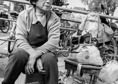Elderly men and women sitting quietly by the roadside